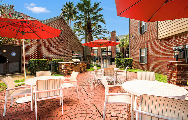 an outdoor patio with tables and chairs and umbrellas