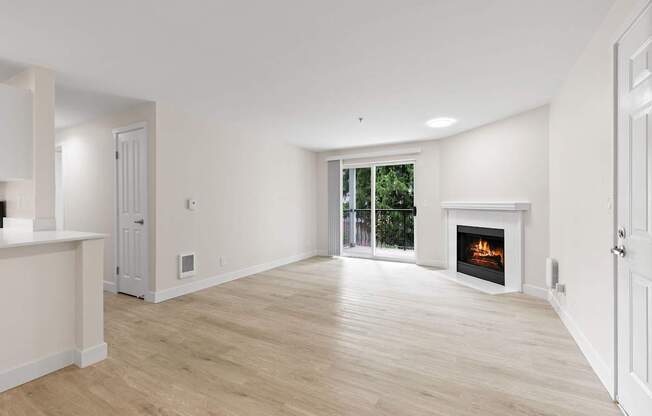 A spacious living room with a fireplace and sliding glass doors.