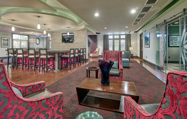 A room with red patterned chairs and a wooden table at Vermella Lyndhurst apartments, New Jersey