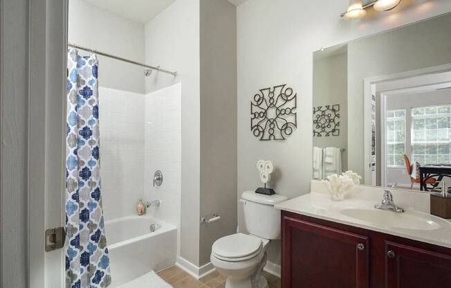 a bathroom with a shower toilet and sink