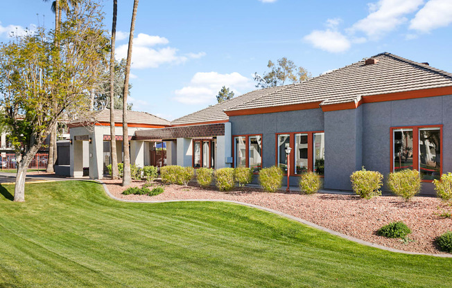 a building with a grassy yard in front of it