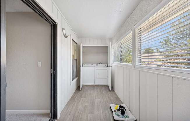 A small laundry room with a washer and dryer.