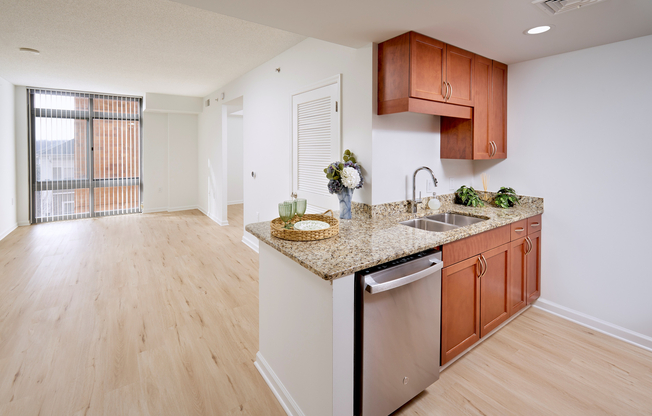 The open-concept living area flows seamlessly into the separate sleeping nook, unified by new vinyl plank wood-style flooring throughout. A Google NEST thermostat and updated contemporary lighting enhance the modern feel of this 578-square-foot layout.