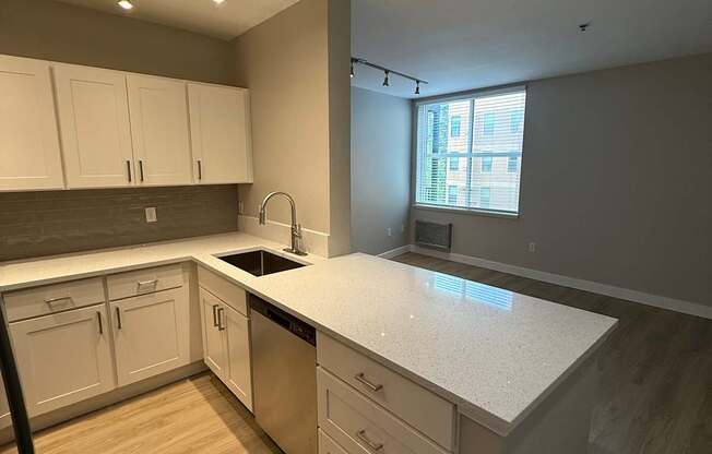 A modern kitchen with a skylight and wooden cabinets.
