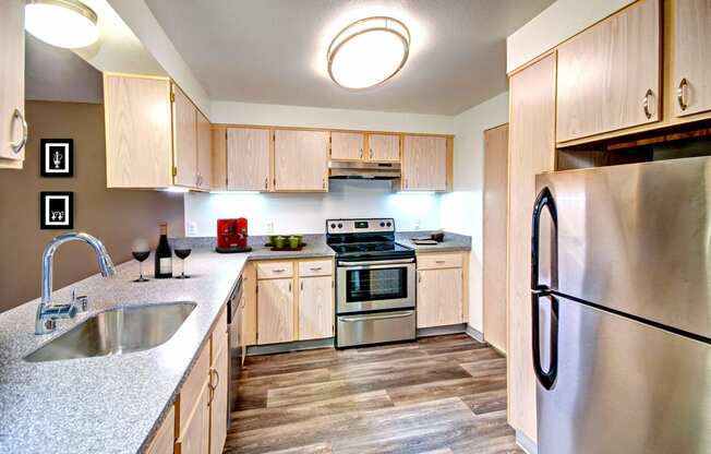 a kitchen with stainless steel appliances and wooden cabinets