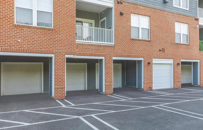 an empty parking lot in front of a brick building