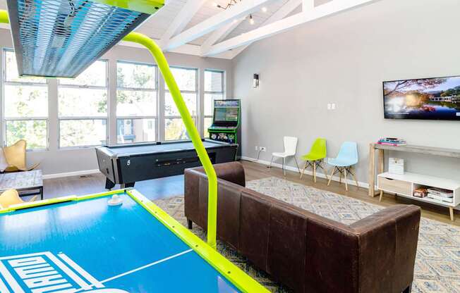 a game room with a pool table and a tv