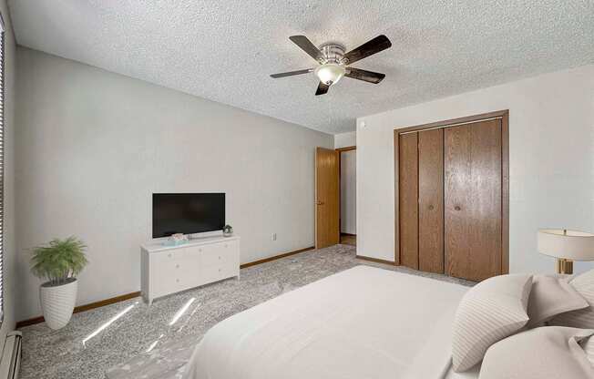 a bedroom with a bed and a ceiling fan at Creekstone Falls, Sioux Falls, SD