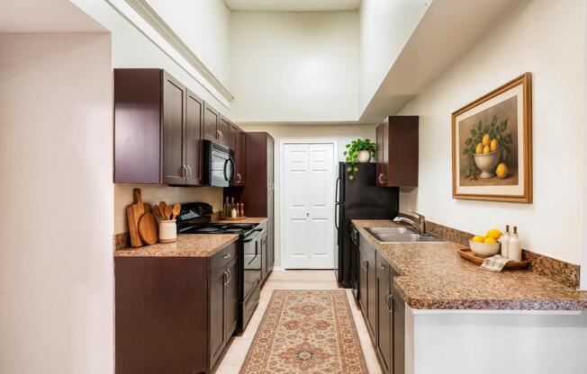 Kitchens feature black appliances, stylish tile backsplash, and Shaker-style cabinetry.