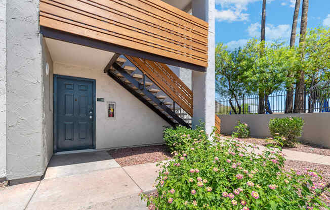 the front door of a building with a staircase leading up to it