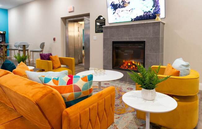 a living room with couches and chairs and a fireplace