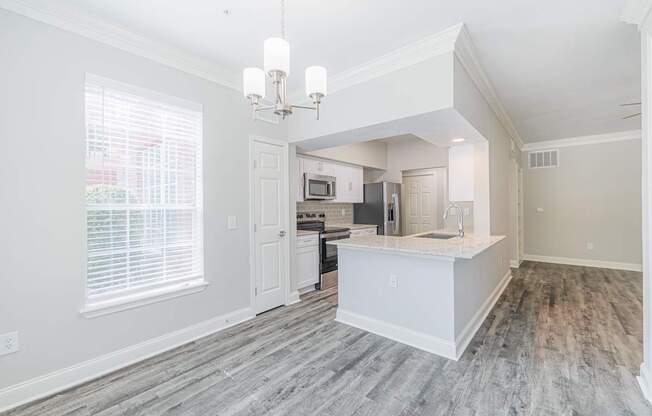 an open kitchen and living room with a large window