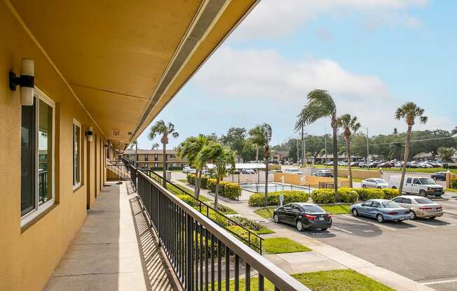 the view of the parking lot from the balcony of a apartment building