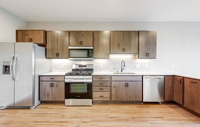 a kitchen with stainless steel appliances and wooden cabinets