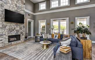 Clubhouse sitting area with large fireplace and tv