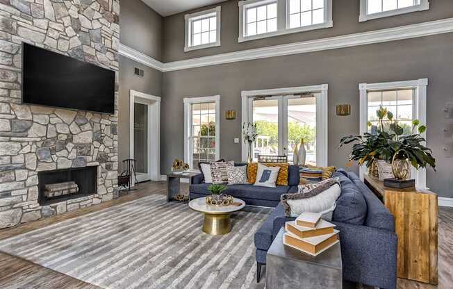 Clubhouse sitting area with large fireplace and tv