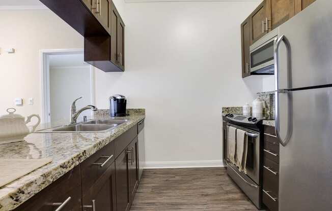 a kitchen with stainless steel appliances and granite counter tops