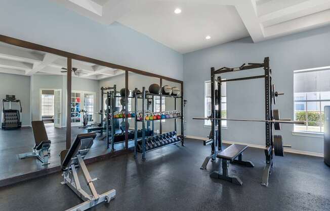 A spacious home gym with a variety of equipment.