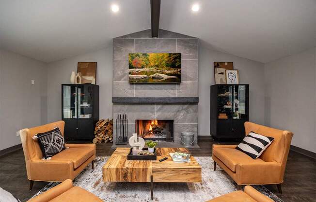 A modern living room with a fireplace and two chairs.
