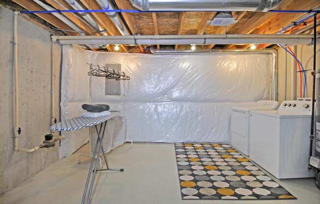a room with a dryer and a wall covered in plastic