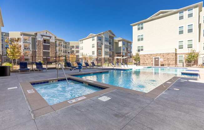 A swimming pool surrounded by apartment buildings.