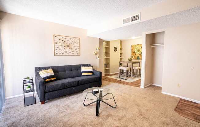 A living room with a grey couch and a coffee table.