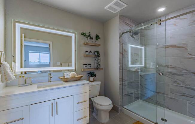 A bathroom with a marble tile shower and a white toilet.at Icon One, Daytona Beach, FL, 32114