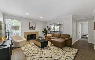 a living room with a couch and a chair and a fireplace