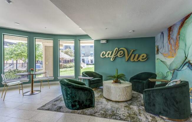 a lobby with green chairs and a green wall with the words café vue on it