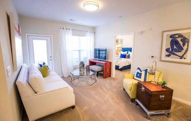 A living room with a white sofa and a wooden side table.