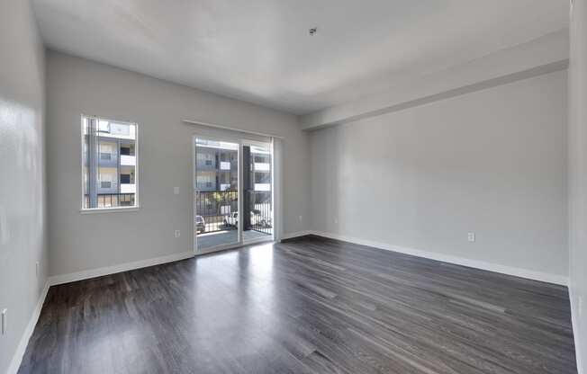 the living room of an apartment and wood floors