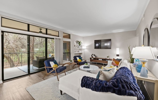 a living room with a white couch and a tv