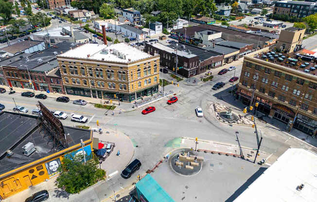 A city intersection with a large building in the background.