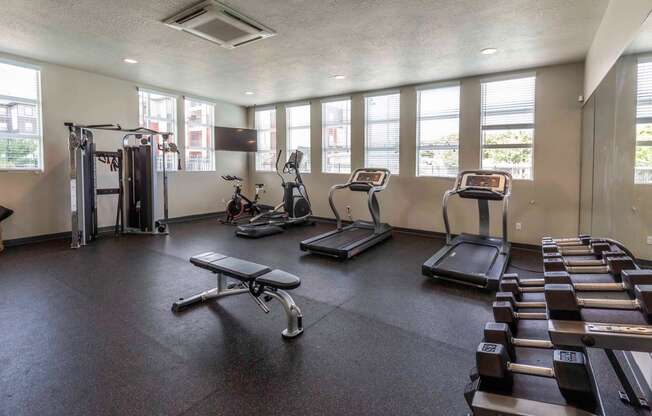 a gym with treadmills and other exercise equipment