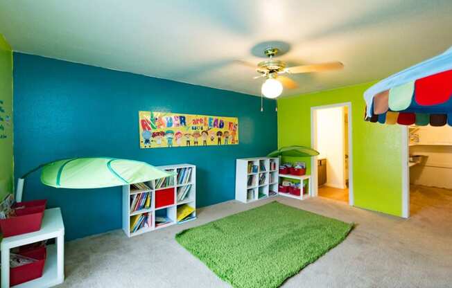 a childrens room with a bed and a ceiling fan