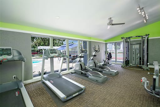 Fitness Center with cardio equipment and windows overlooking a pool