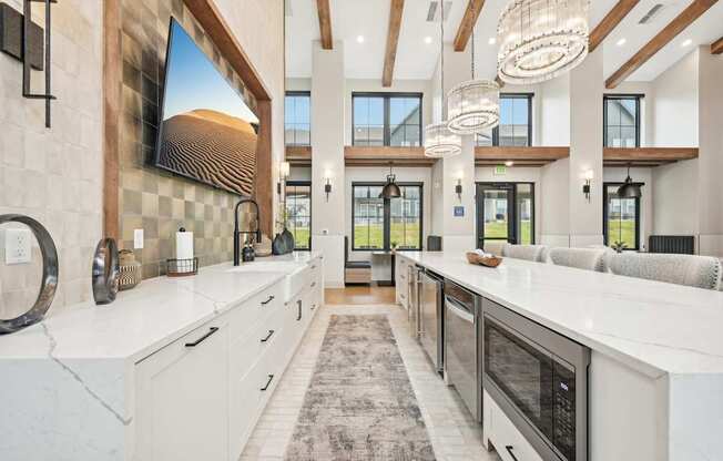 a large kitchen with marble counter tops and white cabinets