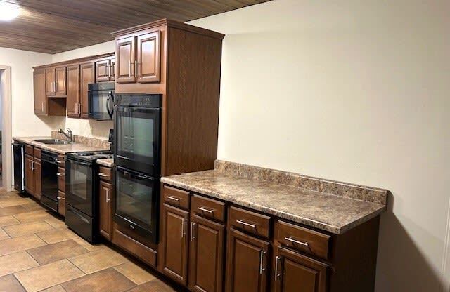 a kitchen with granite counter tops and a refrigerator