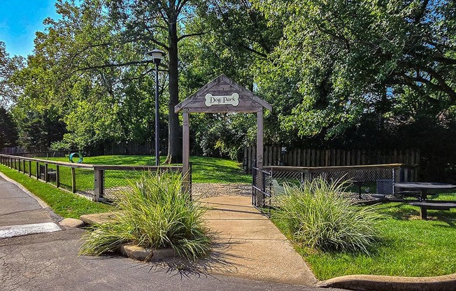 a park with a gate and a sidewalk