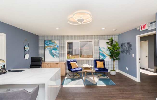 a room with blue walls and a white counter with two chairs and a table