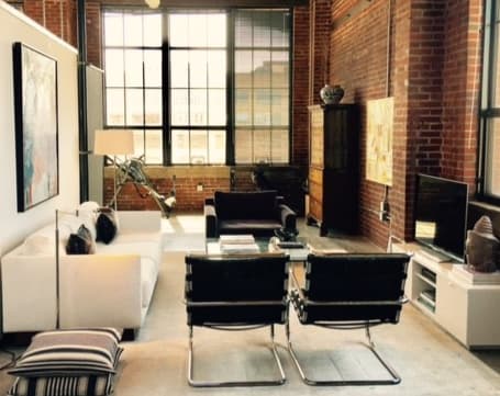 a living room with a white couch and a television