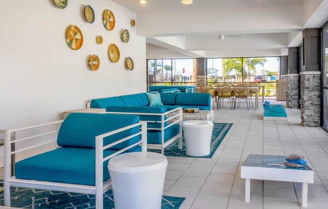 A white and blue living room with a white sofa and a white coffee table.