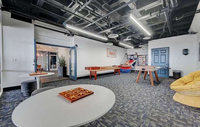 A room with a white table and a yellow chair.
