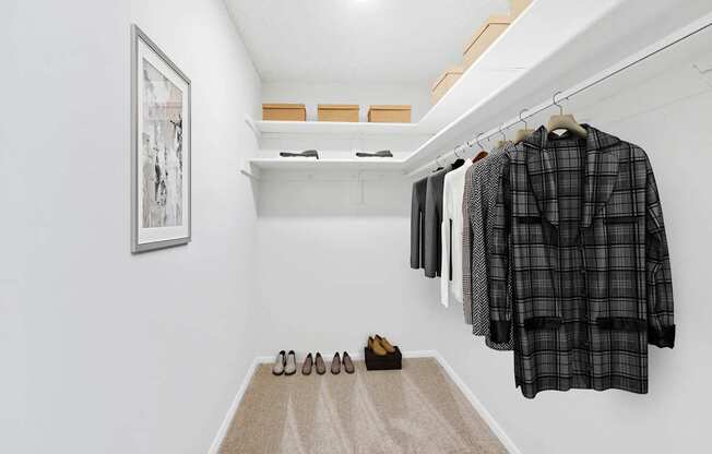 Walk-in closet with clothes at Vistas of Annandale, Virginia, 22003