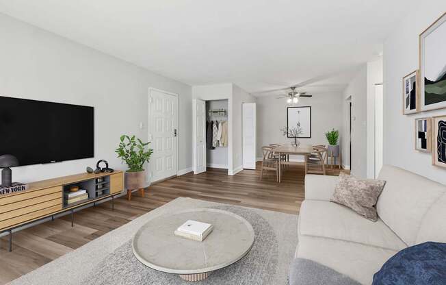 A living room with a white couch and a flat screen TV.