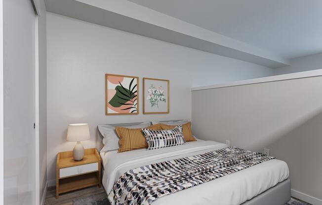 a bedroom with a bed and two paintings on the wall