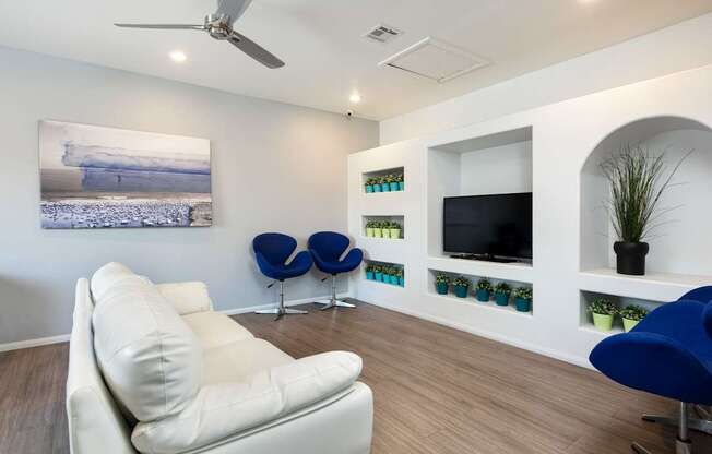 a living room with a white couch and a television