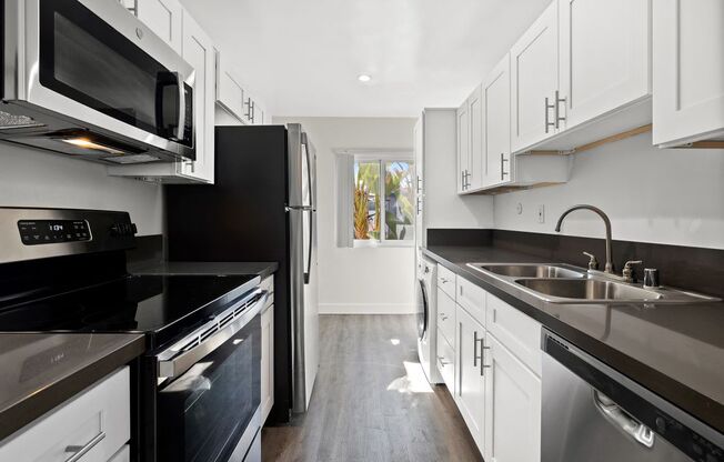 stainless steel appliances, and modern wood cabinets at The Reserve at Warner Center, Woodland Hills, CA, 91367