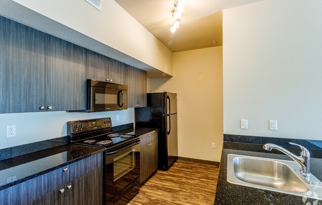 a kitchen with a stove microwave and sink