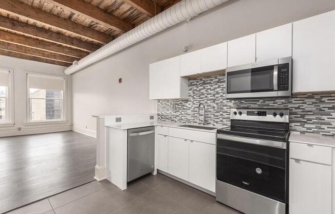 a kitchen with a stove top oven and a microwave